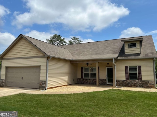 1010 Holliday Pass, Griffin, GA 30223 - view of front of home featuring stone siding, an attached garage, a front lawn, driveway, and ceiling fan
