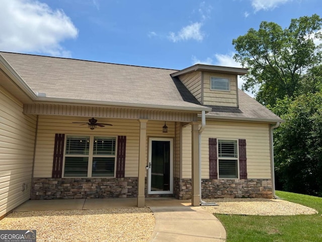 1010 Holliday Pass, Griffin, GA 30223 - entrance to property featuring ceiling fan, stone siding, and a shingled roof