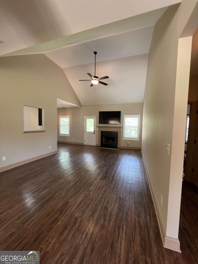 1010 Holliday Pass, Griffin, GA 30223 - unfurnished living room with dark wood-type flooring, ceiling fan, a fireplace, baseboards, and high vaulted ceiling