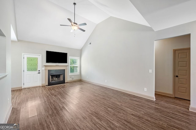 1010 Holliday Pass, Griffin, GA 30223 - unfurnished living room featuring a ceiling fan, wood finished floors, a fireplace with flush hearth, and high vaulted ceiling