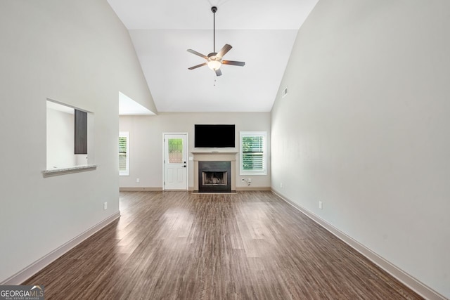 1010 Holliday Pass, Griffin, GA 30223 - unfurnished living room featuring high vaulted ceiling, a ceiling fan, a fireplace with flush hearth, and wood finished floors