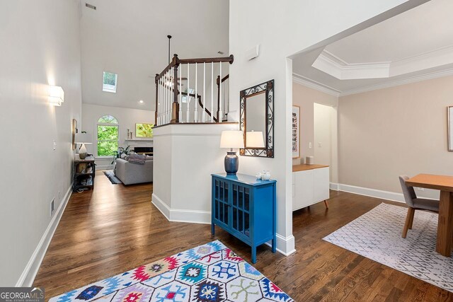 3714 Westbrooke Cir, Brookhaven, GA 30319 - corridor featuring wood finished floors, crown molding, a high ceiling, baseboards, and stairs