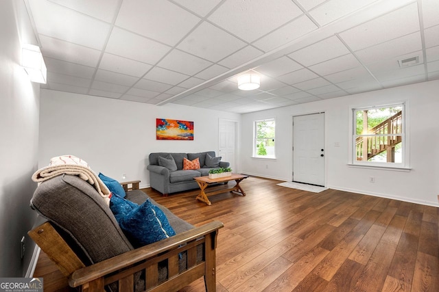 3714 Westbrooke Cir, Brookhaven, GA 30319 - living room featuring a drop ceiling, hardwood / wood-style flooring, and baseboards
