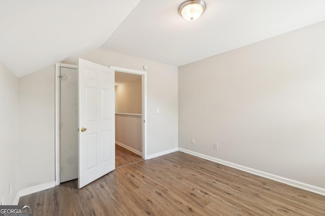 1177 Arlington Ave SW, Atlanta, GA 30310 - unfurnished bedroom with wood finished floors, vaulted ceiling, and baseboards