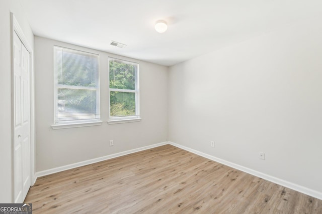 1177 Arlington Ave SW, Atlanta, GA 30310 - unfurnished bedroom featuring light wood finished floors, baseboards, and a closet