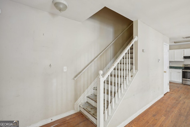 1177 Arlington Ave SW, Atlanta, GA 30310 - staircase with baseboards and wood finished floors
