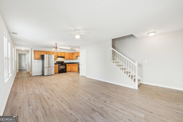 1177 Arlington Ave SW, Atlanta, GA 30310 - unfurnished living room featuring light wood-style flooring, stairs, ceiling fan, baseboards, and a chandelier