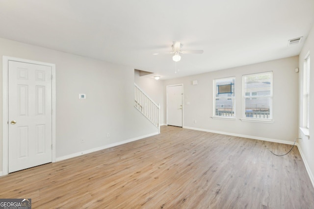 1177 Arlington Ave SW, Atlanta, GA 30310 - unfurnished living room featuring a ceiling fan, stairway, light wood-style floors, and baseboards