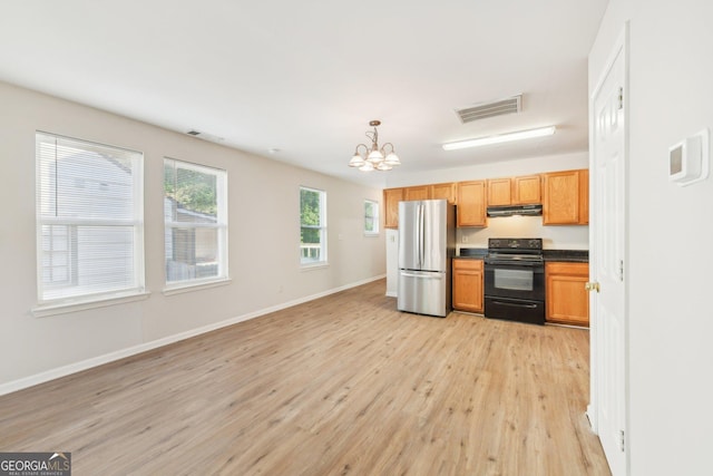 1177 Arlington Ave SW, Atlanta, GA 30310 - kitchen featuring black range with electric stovetop, freestanding refrigerator, under cabinet range hood, light wood finished floors, and a chandelier