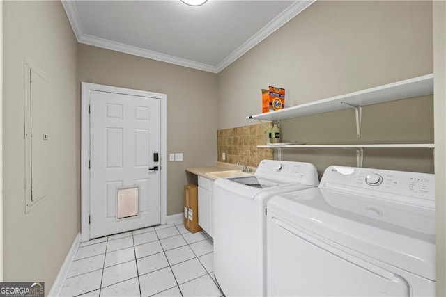 1451 Tappan Spur Dr, Watkinsville, GA 30677 - laundry area with cabinet space, crown molding, washer and dryer, baseboards, and light tile patterned floors