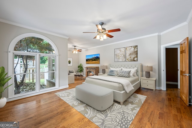 1451 Tappan Spur Dr, Watkinsville, GA 30677 - bedroom with ornamental molding, wood finished floors, ceiling fan, a fireplace, and baseboards