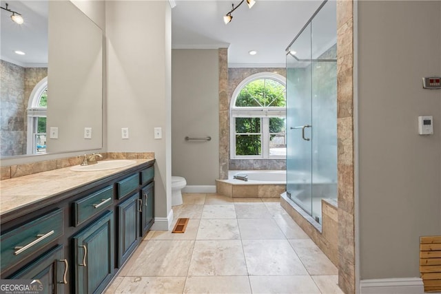 1451 Tappan Spur Dr, Watkinsville, GA 30677 - bathroom with ornamental molding, vanity, a garden tub, toilet, and a stall shower