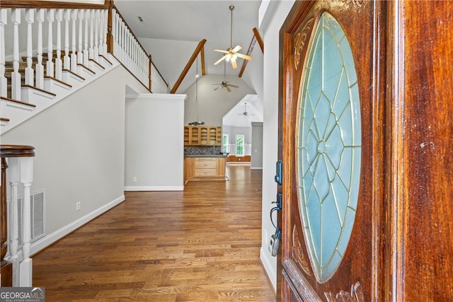 1451 Tappan Spur Dr, Watkinsville, GA 30677 - foyer entrance featuring a ceiling fan, high vaulted ceiling, wood finished floors, baseboards, and stairway