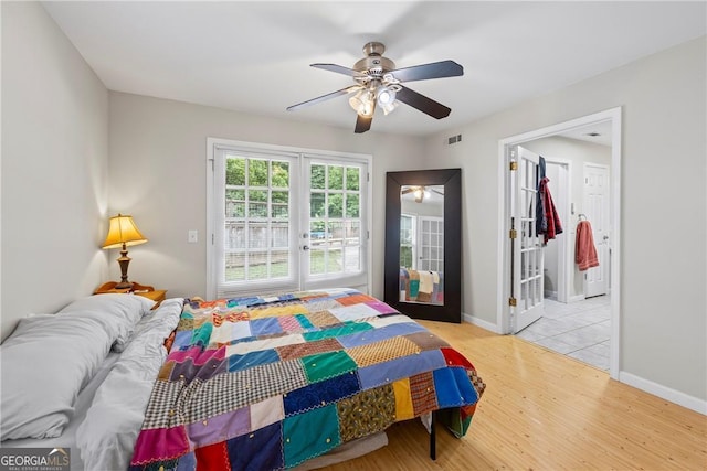 1451 Tappan Spur Dr, Watkinsville, GA 30677 - bedroom featuring french doors, wood finished floors, baseboards, and a ceiling fan