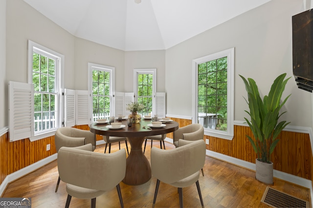 1451 Tappan Spur Dr, Watkinsville, GA 30677 - dining area with wainscoting, plenty of natural light, wood finished floors, wooden walls, and high vaulted ceiling