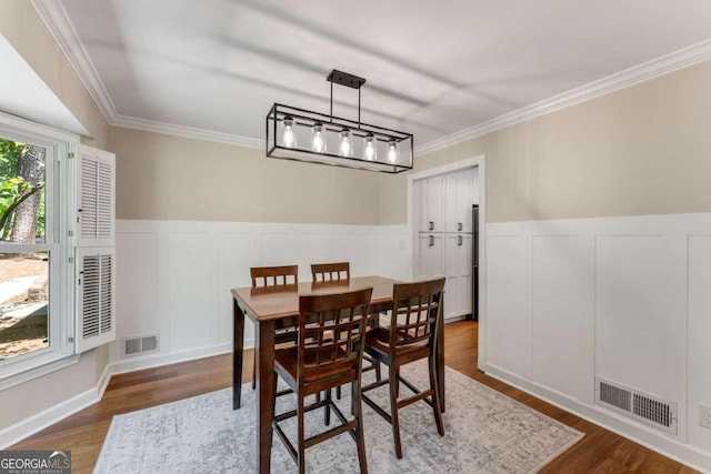 2356 Defoors Ferry Rd NW, Atlanta, GA 30318 - dining room with dark wood-style floors, crown molding, a decorative wall, and wainscoting