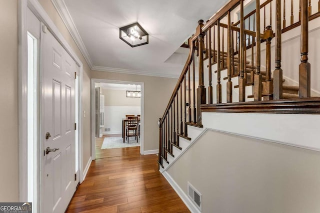 2356 Defoors Ferry Rd NW, Atlanta, GA 30318 - entrance foyer featuring stairs, wood-type flooring, crown molding, and baseboards