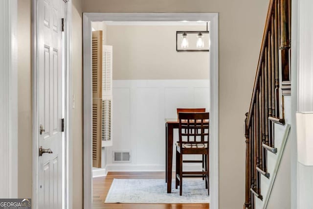 2356 Defoors Ferry Rd NW, Atlanta, GA 30318 - hallway featuring wood finished floors, an upstairs landing, and a decorative wall