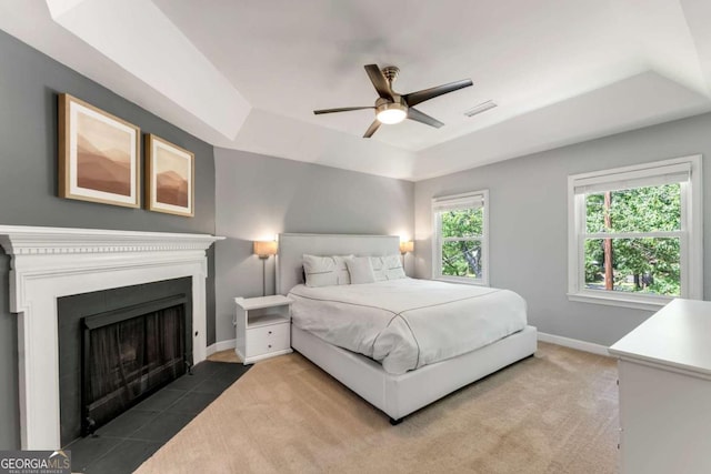 2356 Defoors Ferry Rd NW, Atlanta, GA 30318 - bedroom with a raised ceiling, baseboards, ceiling fan, and a fireplace with flush hearth