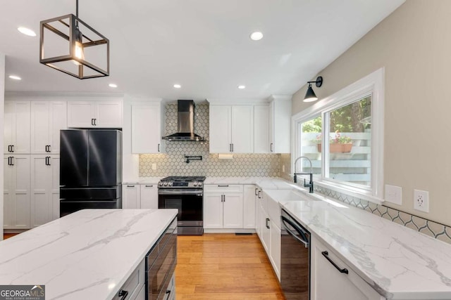 2356 Defoors Ferry Rd NW, Atlanta, GA 30318 - kitchen featuring freestanding refrigerator, wall chimney range hood, gas stove, dishwashing machine, and a sink