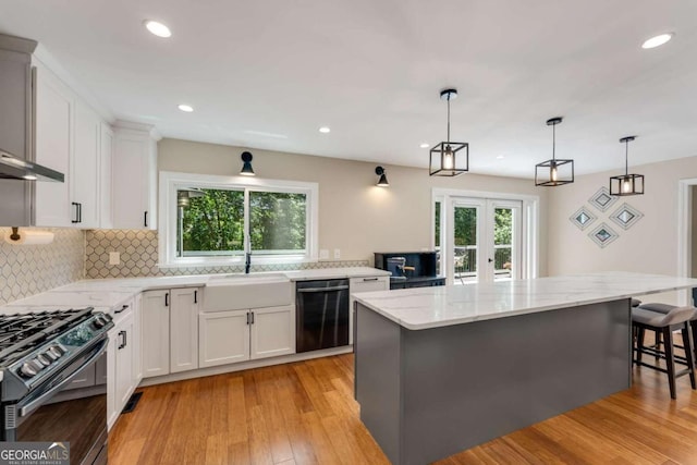 2356 Defoors Ferry Rd NW, Atlanta, GA 30318 - kitchen featuring dishwashing machine, a sink, light stone countertops, backsplash, and white cabinetry