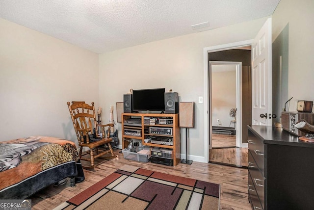 287 Jeremy Dr, Colbert, GA 30628 - bedroom featuring wood finished floors and a textured ceiling