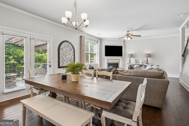 2127 Apple Orchard Way, Austell, GA 30168 - dining space with a ceiling fan, ornamental molding, a lit fireplace, a chandelier, and dark wood finished floors