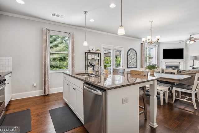 2127 Apple Orchard Way, Austell, GA 30168 - kitchen with stainless steel dishwasher, plenty of natural light, crown molding, a breakfast bar area, and dark stone countertops