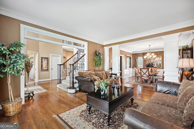3495 Mill Bridge Dr, Marietta, GA 30062 - living room featuring decorative columns, crown molding, wood finished floors, stairs, and a chandelier