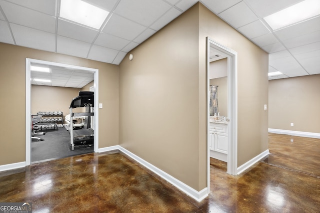 3495 Mill Bridge Dr, Marietta, GA 30062 - corridor featuring a paneled ceiling, finished concrete floors, and baseboards