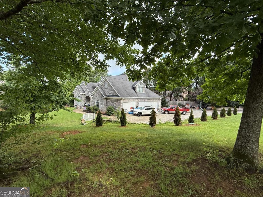 3393 Childers Rd NE, Roswell, GA 30075 - view of green lawn featuring driveway and an attached garage