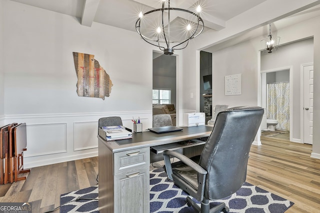 390 Cushing St, Senoia, GA 30276 - office space with a chandelier, beam ceiling, wood finished floors, wainscoting, and a decorative wall
