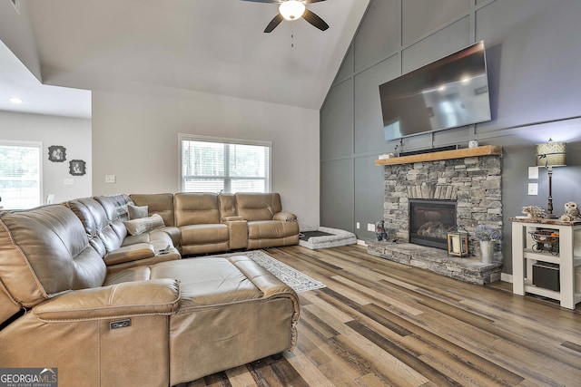 390 Cushing St, Senoia, GA 30276 - living room featuring high vaulted ceiling, a ceiling fan, wood finished floors, a stone fireplace, and recessed lighting