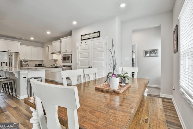 390 Cushing St, Senoia, GA 30276 - dining space with dark wood finished floors, baseboards, and recessed lighting