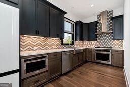320 Dodd Ln, Alpharetta, GA 30005 - kitchen with oven, light countertops, wall chimney exhaust hood, decorative backsplash, and recessed lighting