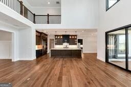 320 Dodd Ln, Alpharetta, GA 30005 - living area with a high ceiling, dark wood finished floors, and baseboards