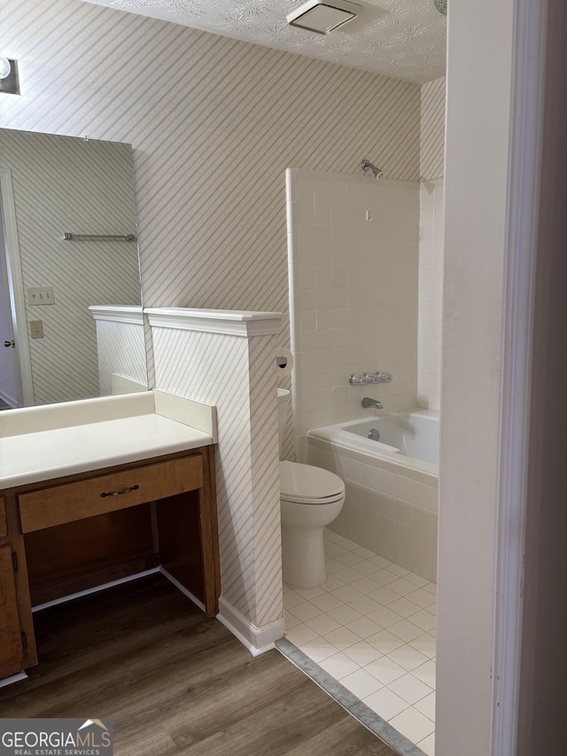 135 Courtyard Ln, Fayetteville, GA 30215 - full bath with toilet, vanity, tub / shower combination, and wood finished floors