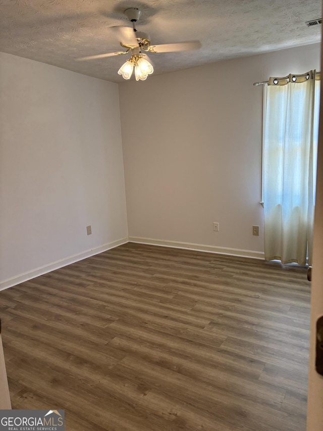 135 Courtyard Ln, Fayetteville, GA 30215 - empty room featuring dark wood-type flooring, a ceiling fan, a textured ceiling, and baseboards