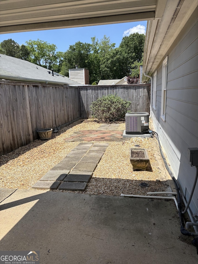135 Courtyard Ln, Fayetteville, GA 30215 - fenced backyard featuring central AC and a patio area
