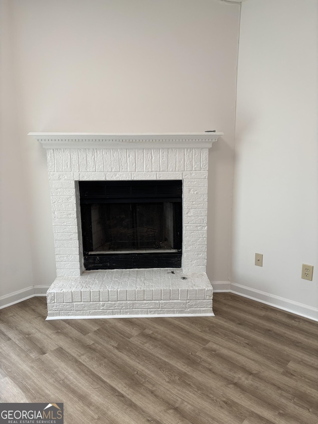 135 Courtyard Ln, Fayetteville, GA 30215 - detailed view of a brick fireplace, wood finished floors, and baseboards