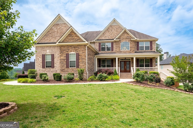 6585 Canyon Cv, Cumming, GA 30028 - craftsman house with covered porch, french doors, and a front lawn