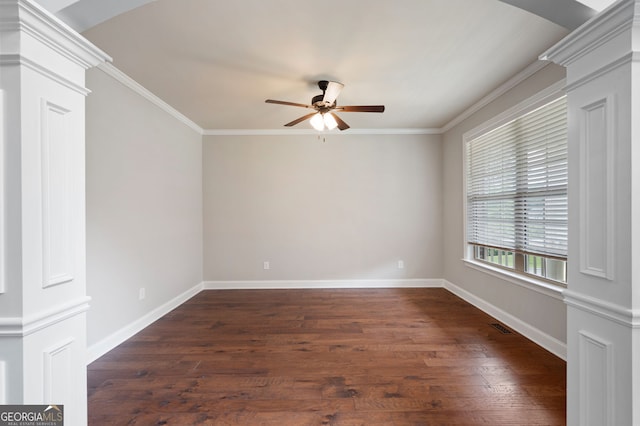 6585 Canyon Cv, Cumming, GA 30028 - empty room featuring ornate columns, a ceiling fan, dark wood finished floors, and ornamental molding