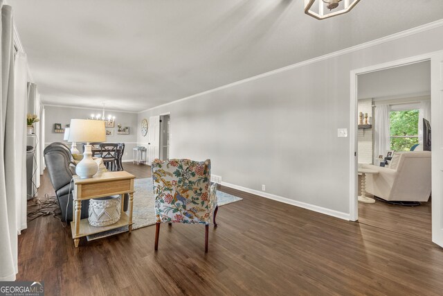 2121 Elysian Cir, Gainesville, GA 30501 - living area with crown molding, a chandelier, wood finished floors, and baseboards