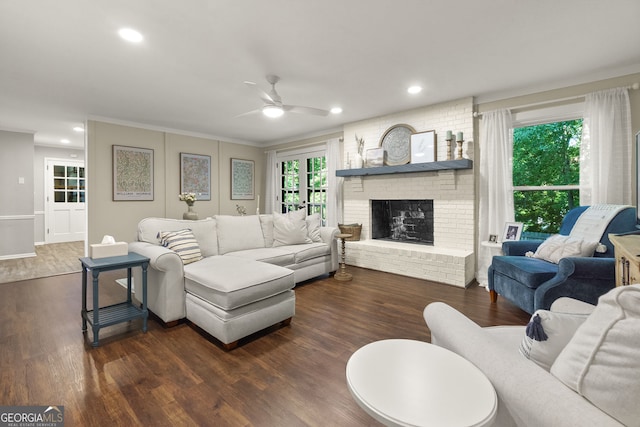 2121 Elysian Cir, Gainesville, GA 30501 - living room with a ceiling fan, dark wood-type flooring, a brick fireplace, recessed lighting, and crown molding