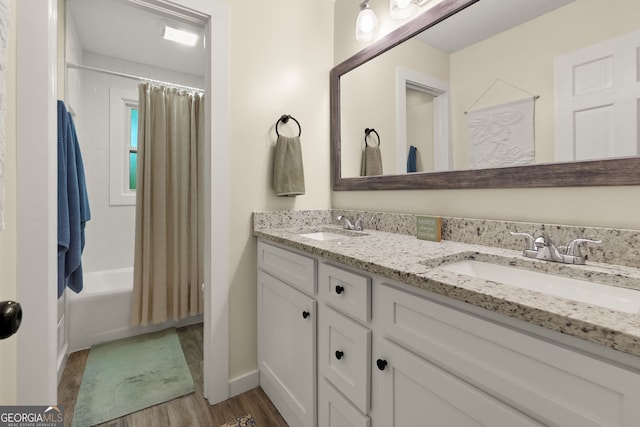 2121 Elysian Cir, Gainesville, GA 30501 - full bathroom with double vanity, wood finished floors, shower / tub combo with curtain, and baseboards