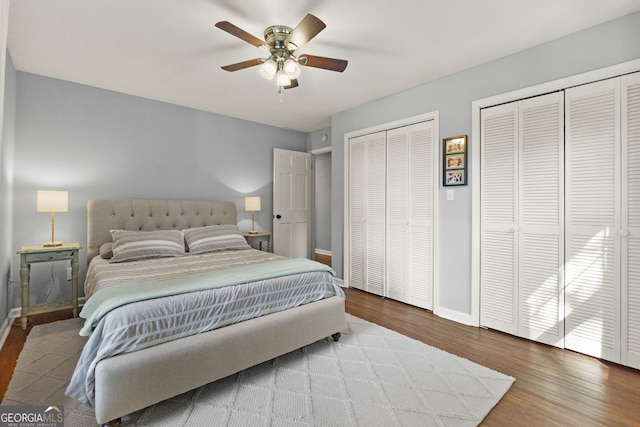 2121 Elysian Cir, Gainesville, GA 30501 - bedroom featuring two closets, wood finished floors, baseboards, and ceiling fan
