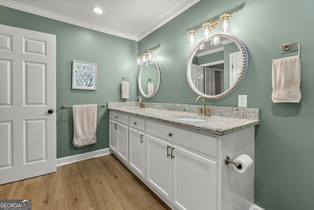 2121 Elysian Cir, Gainesville, GA 30501 - bathroom featuring double vanity, ornamental molding, baseboards, wood finished floors, and recessed lighting