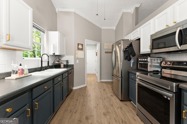 7277 Plum Creek Dr, Gainesville, GA 30507 - kitchen with stainless steel appliances, a sink, white cabinets, crown molding, and light wood-style floors