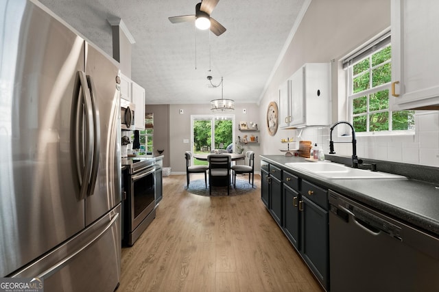 7277 Plum Creek Dr, Gainesville, GA 30507 - kitchen with stainless steel appliances, a sink, a textured ceiling, backsplash, and dark countertops