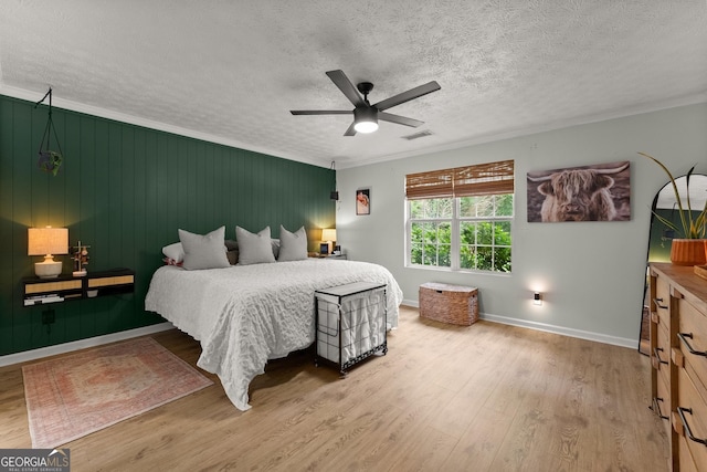 7277 Plum Creek Dr, Gainesville, GA 30507 - bedroom featuring wood finished floors, a textured ceiling, ornamental molding, baseboards, and ceiling fan